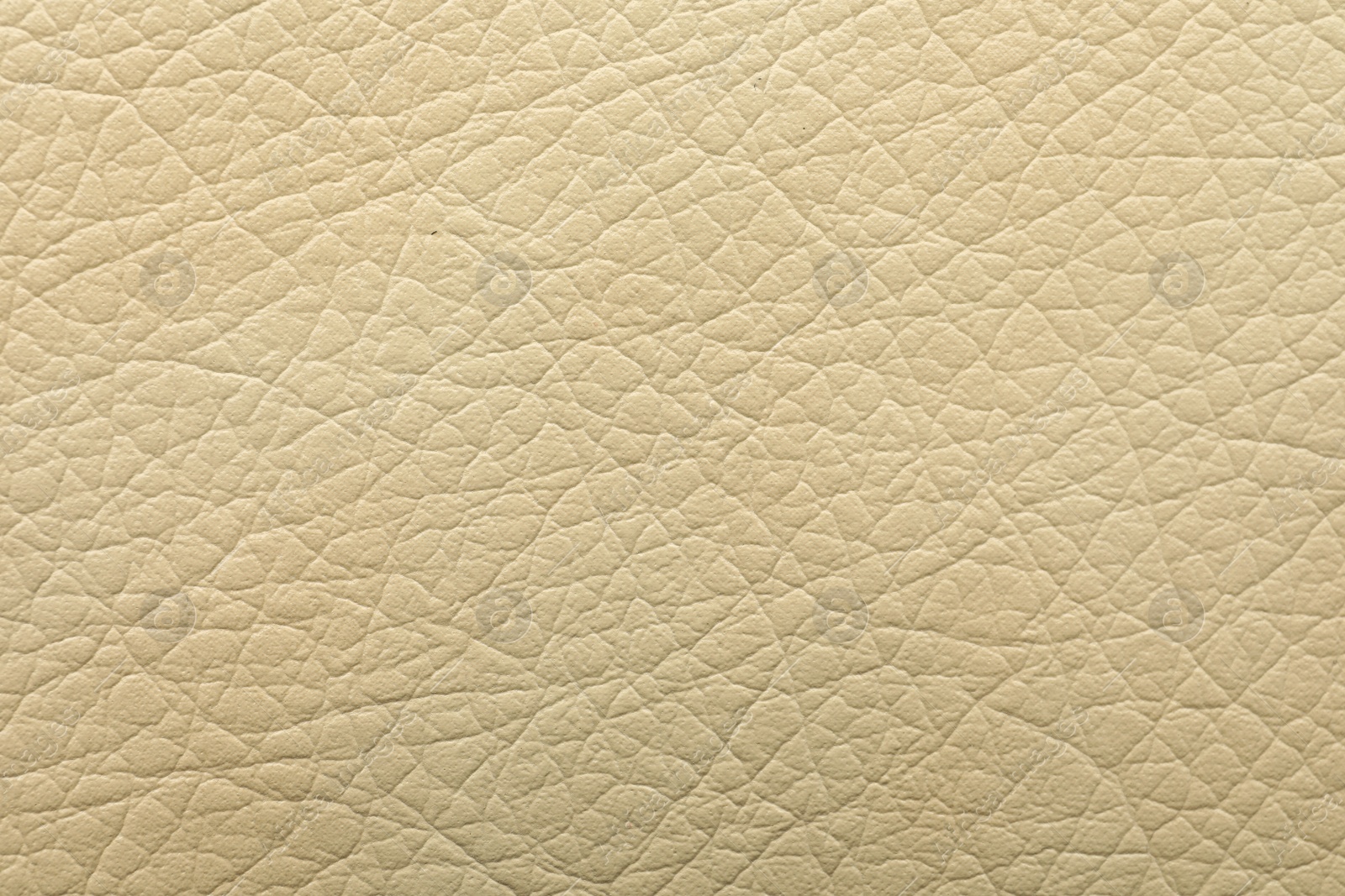 Photo of Texture of beige leather as background, closeup