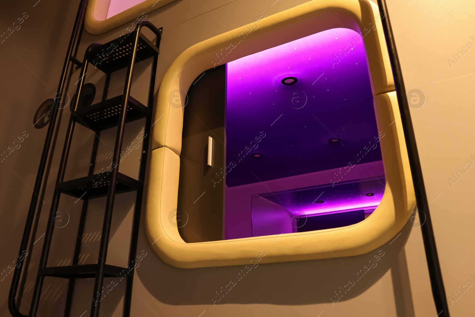 Photo of Capsule with purple light in modern pod hostel