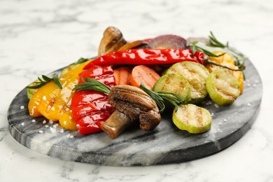 Delicious grilled vegetables on white marble table, closeup
