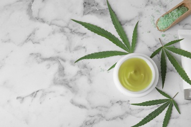 Jar of hemp cream on marble table, flat lay with space for text. Organic cosmetics