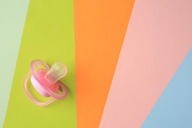 Photo of New baby pacifier on color background, top view. Space for text