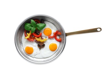 Photo of Tasty fried eggs with vegetables in pan isolated on white, top view