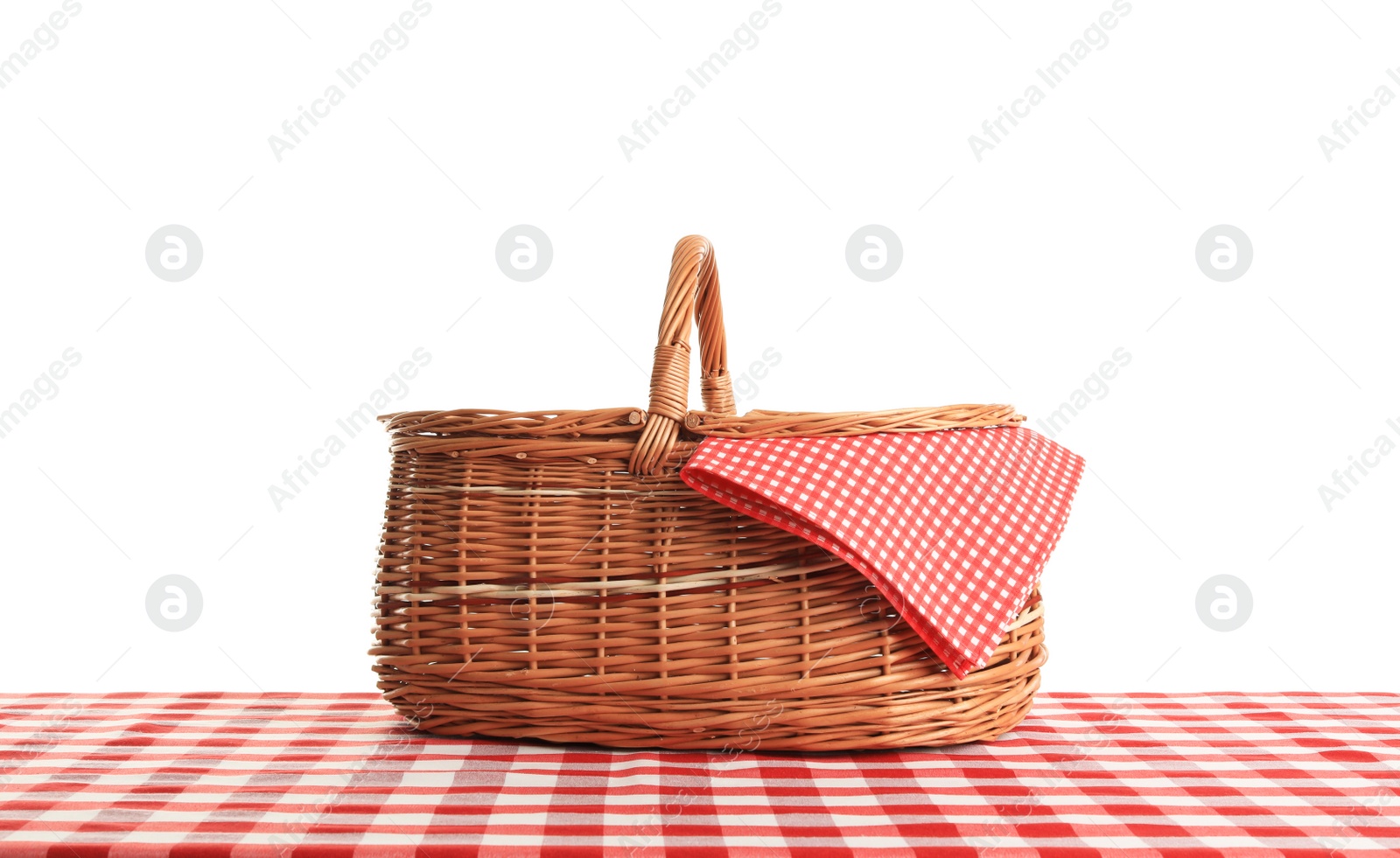 Photo of Empty picnic basket on checkered tablecloth against white background