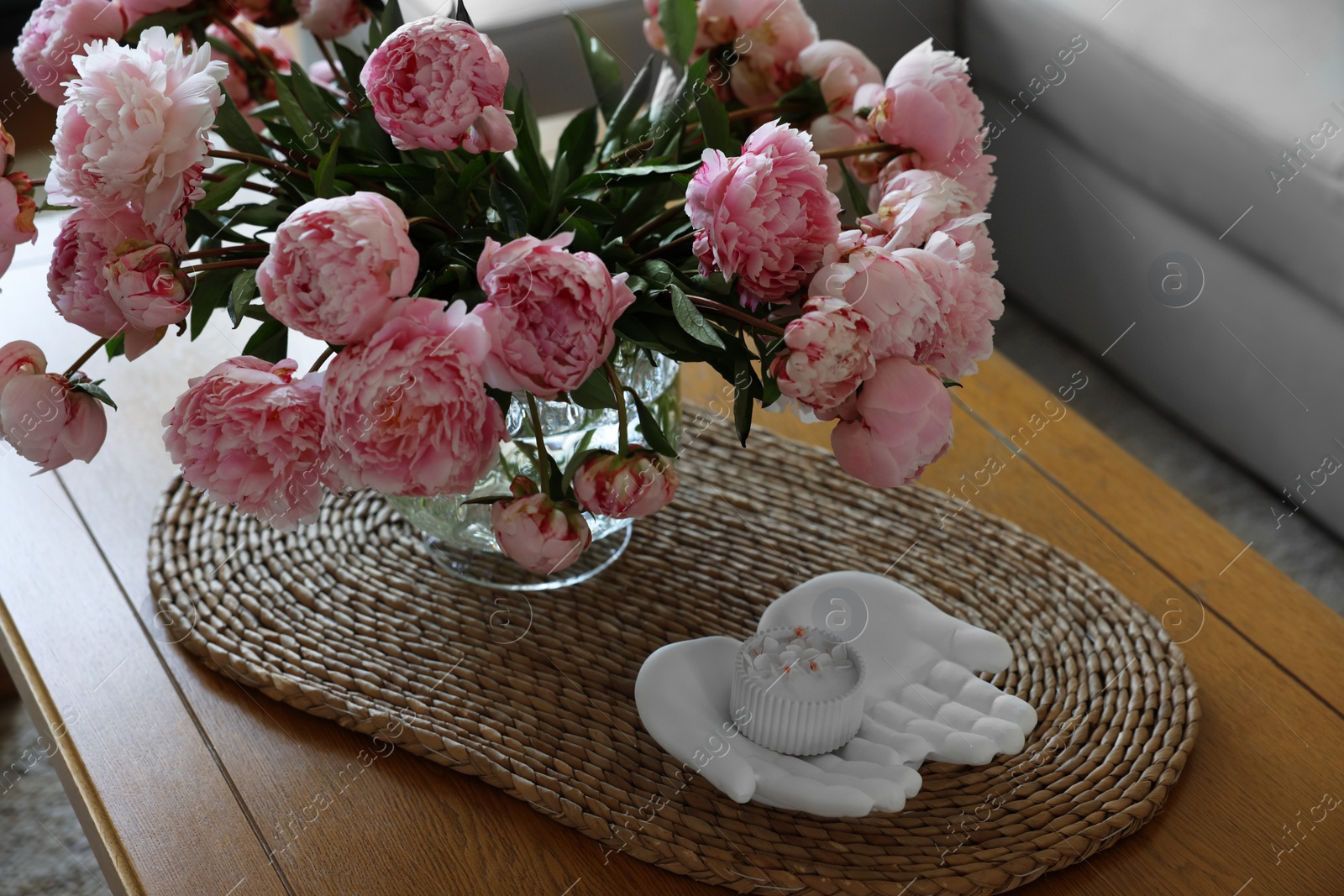 Photo of Beautiful pink peonies in vase on table at home. Interior design