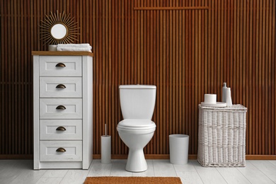 Photo of Ceramic toilet bowl in stylish bathroom. Idea for interior design