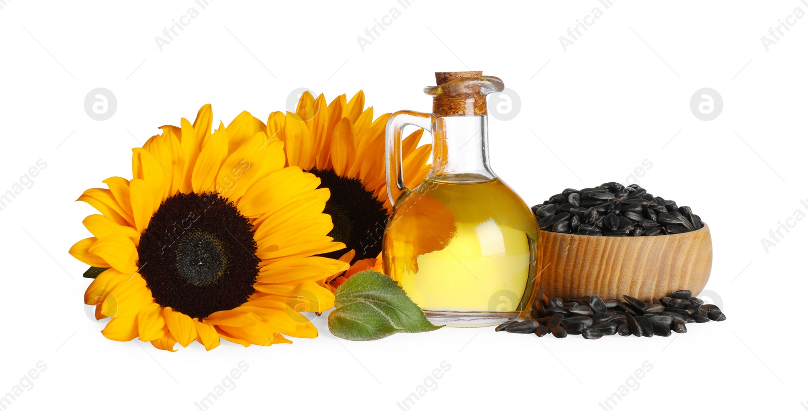 Photo of Sunflower cooking oil, seeds and yellow flowers on white background