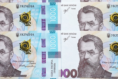 Photo of Ukrainian money as background, top view. National currency