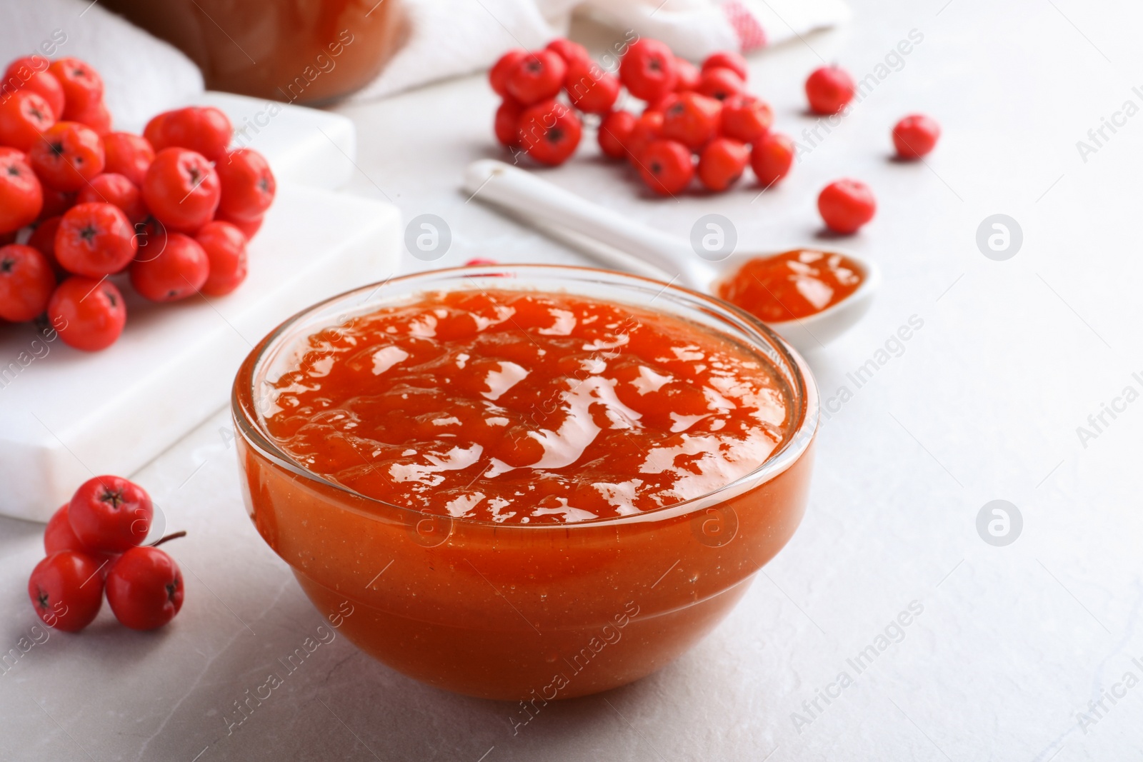 Photo of Delicious rowan jam in bowl on light table