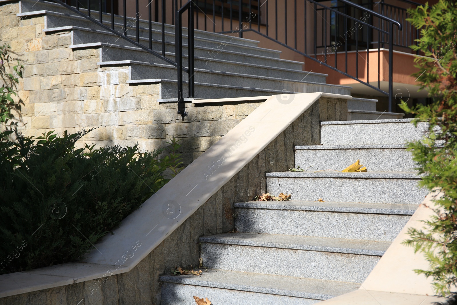 Photo of View of beautiful grey concrete stairs near plants outdoors