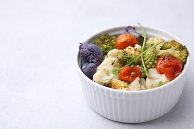 Delicious salad with cauliflower and tomato on white table. Space for text