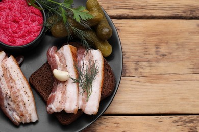 Tasty pork fatback served on wooden table, top view. Space for text