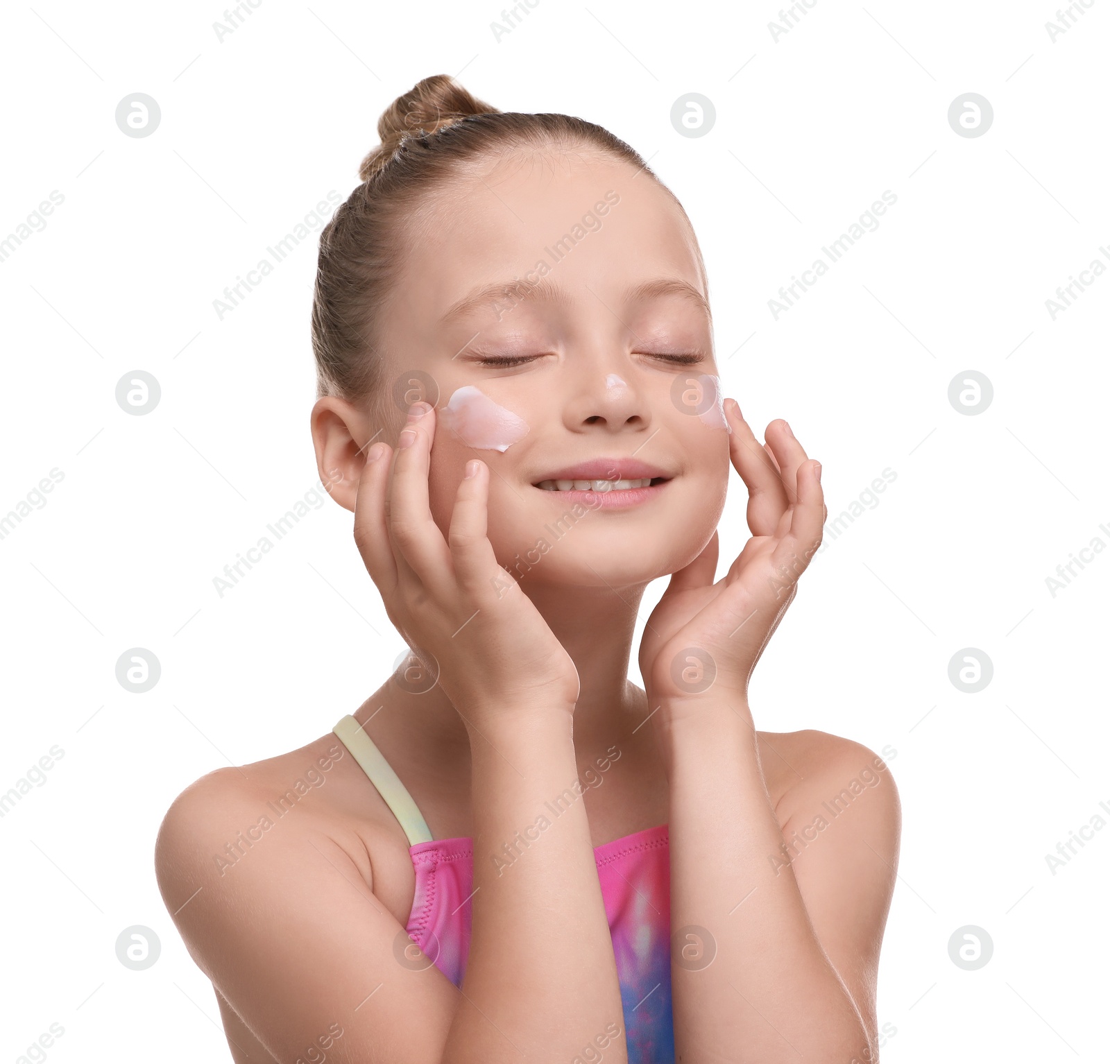 Photo of Happy girl applying sun protection cream onto her face isolated on white