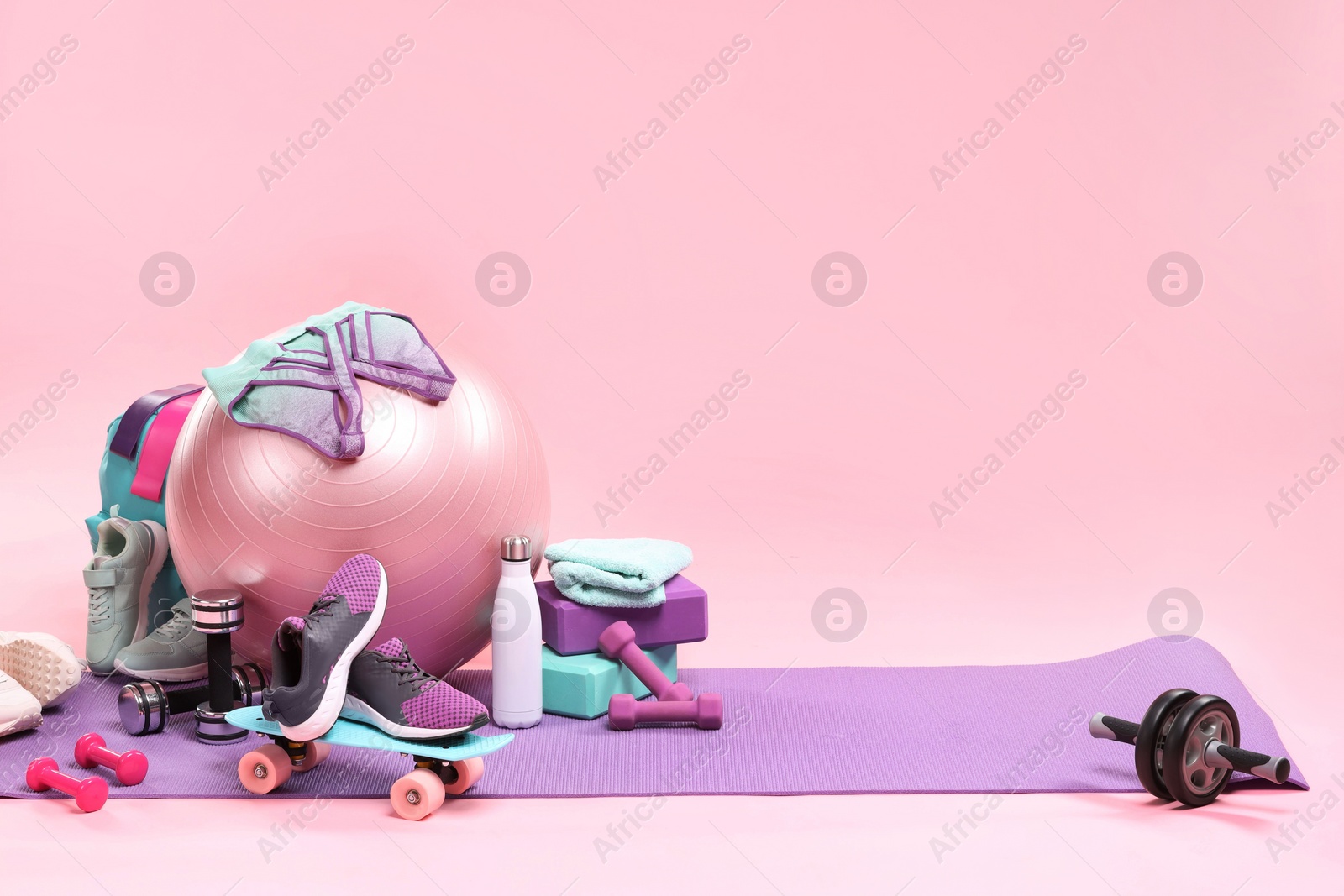 Photo of Many different sports equipment on pink background, space for text