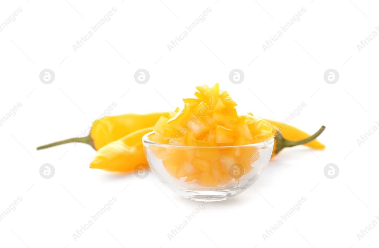 Photo of Bowl with cut ripe hot chili pepper on white background