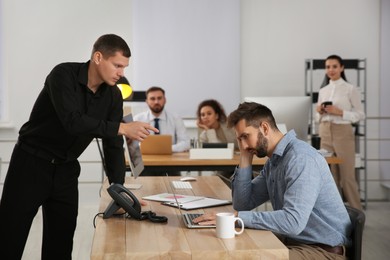 Photo of Boss dismissing man from work in office