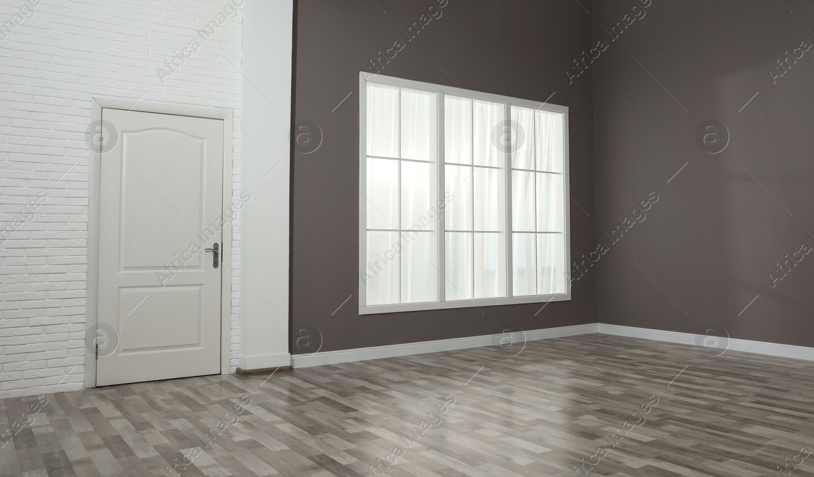 Photo of Empty room with brown walls and large window