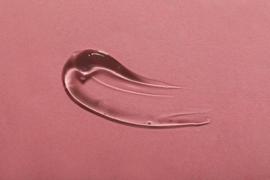 Photo of Sample of cosmetic gel on pink background, top view
