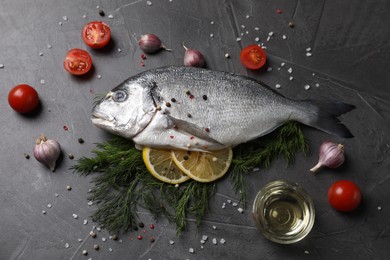 Photo of Fresh dorado fish and ingredients on grey table, flat lay