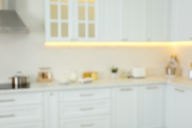 Photo of Blurred view of modern kitchen interior with stylish furniture