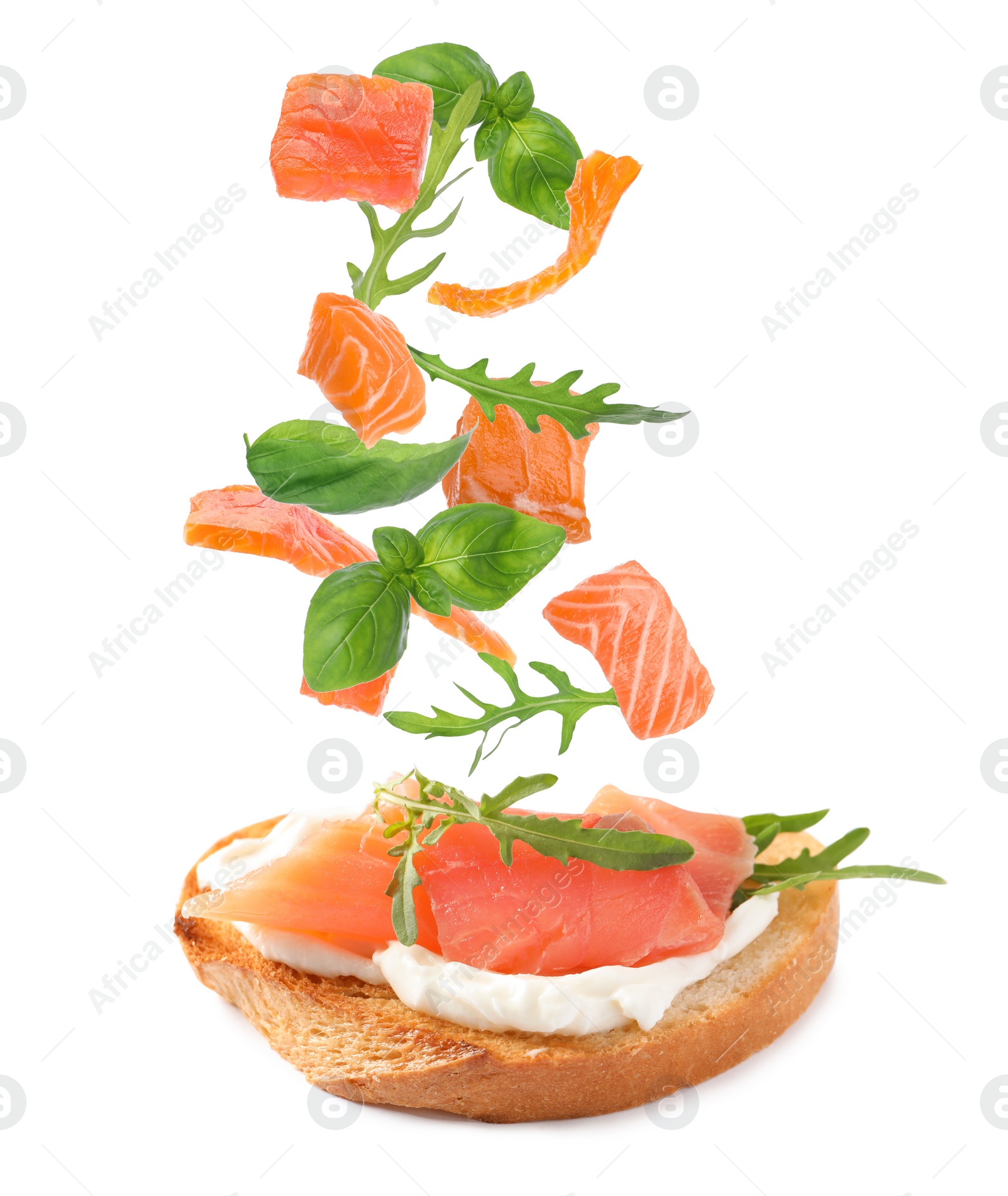 Tasty bruschetta with flying ingredients on white background Image of Tasty bruschetta with flying ingredients on white background