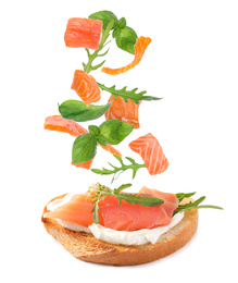 Image of Tasty bruschetta with flying ingredients on white background