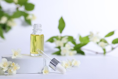 Photo of Presentation of essential oil in bottle and beautiful jasmine flowers on white background