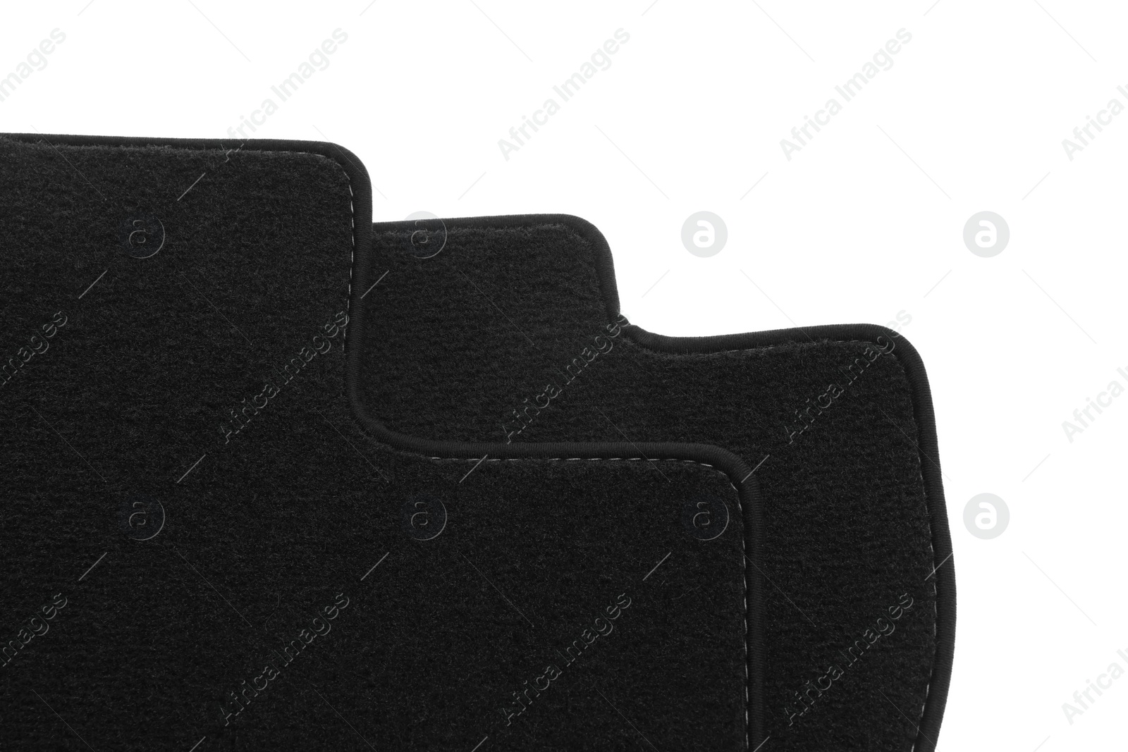 Photo of Black car floor carpets on white background, closeup