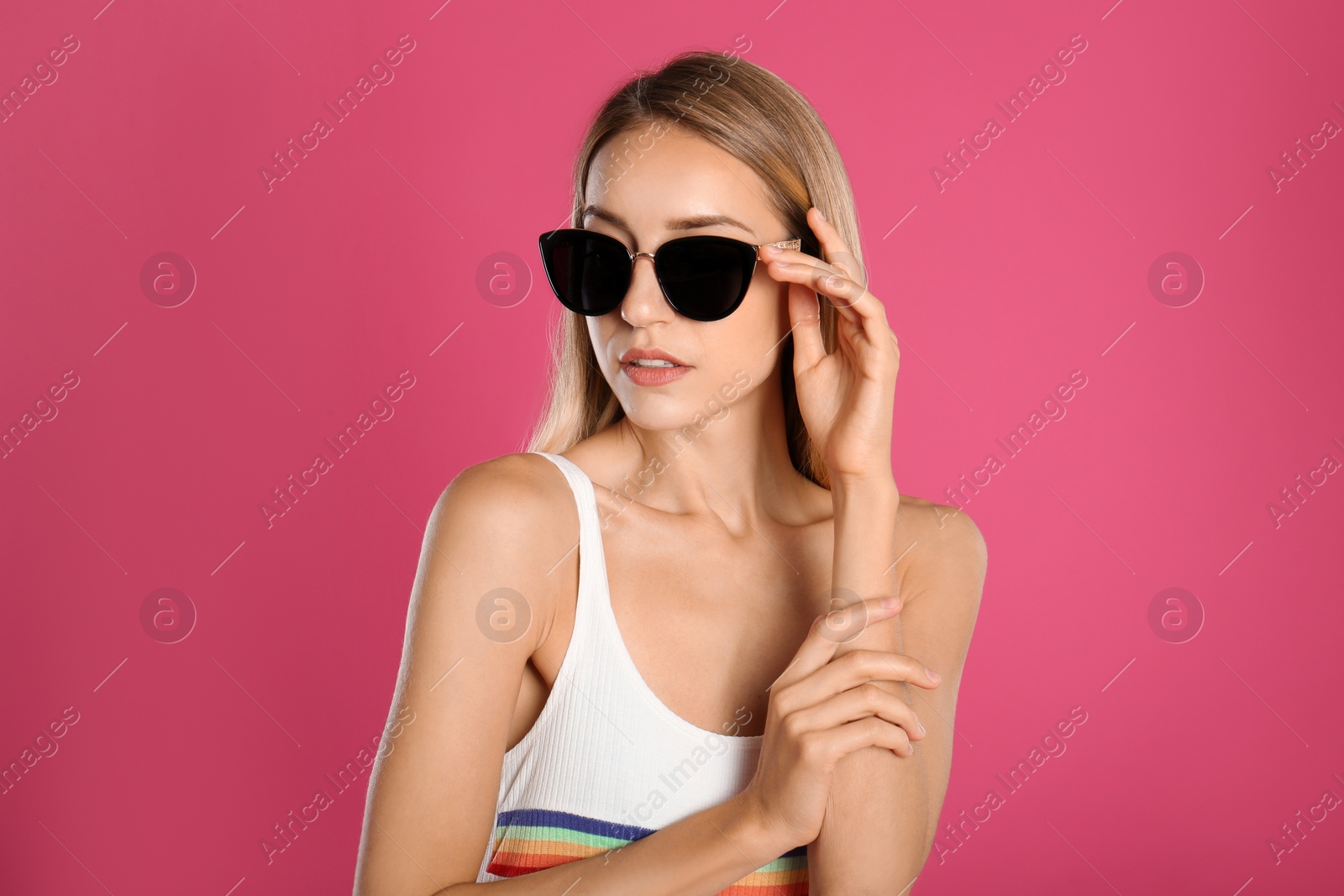 Beautiful woman in stylish sunglasses on pink background Photo of Beautiful woman in stylish sunglasses on pink background