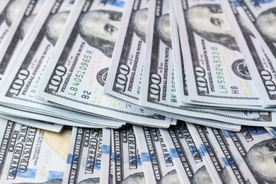 Photo of Dollar banknotes as background, closeup view. Money exchange