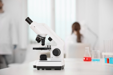 Photo of Modern microscope on white table in laboratory. Medical research