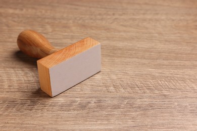 Photo of One stamp tool on wooden table, space for text