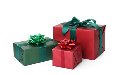 Photo of Red and green gift boxes with bows on white background