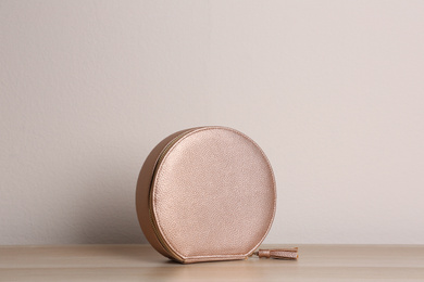 Photo of Stylish leather woman's bag on wooden table