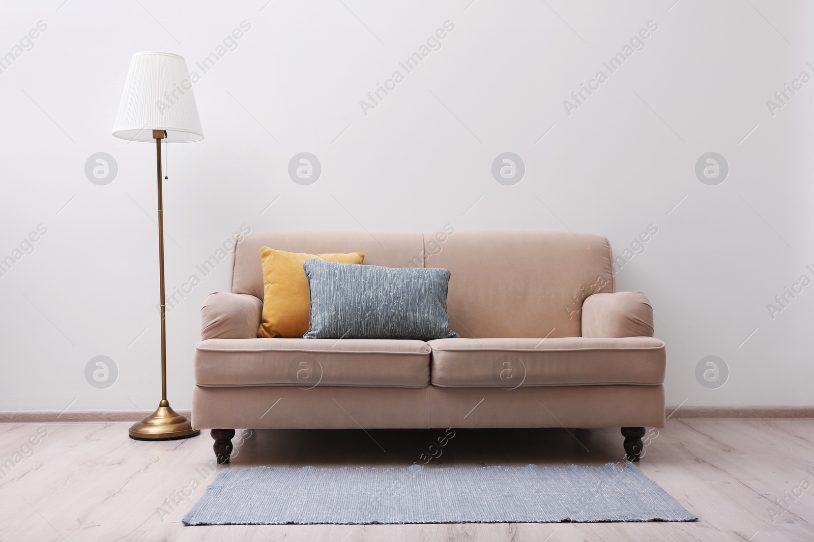 Photo of Simple room interior with comfortable beige sofa