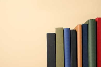 Photo of Many different hardcover books on yellow background, space for text