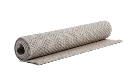 Photo of Rolled grey carpet on white background. Interior element
