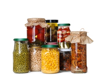 Photo of Different jars with pickled vegetables on white background