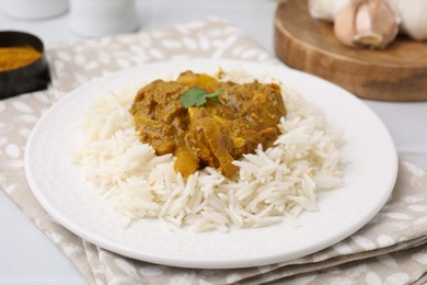 Photo of Delicious chicken curry with rice on table, closeup