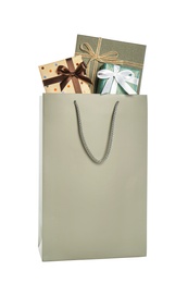 Photo of Paper shopping bag full of gift boxes isolated on white