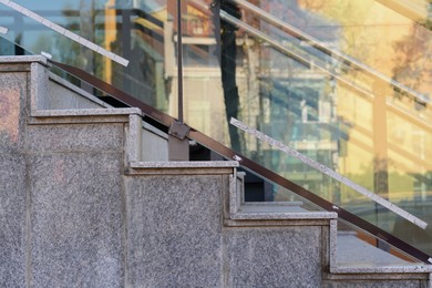 Photo of Beautiful grey stairs with tempered glass outdoors