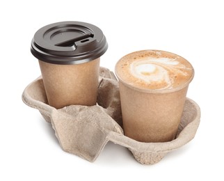 Photo of Takeaway paper cups with coffee in cardboard holder on white background