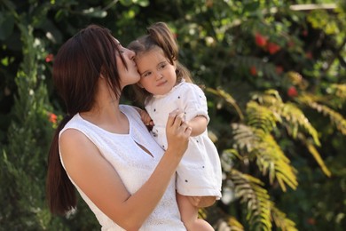 Photo of Mother with her cute daughter spending time together in park