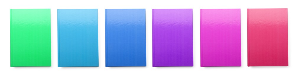 Image of Set with different multicolored planners on white background, top view. Banner design