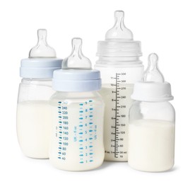 Photo of Many feeding bottles with infant formula on white background
