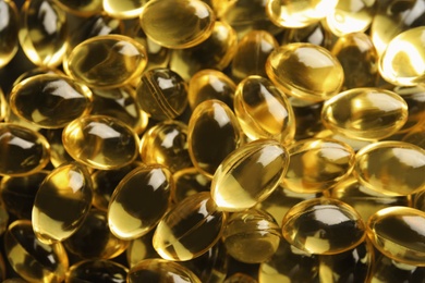 Photo of Cod liver oil pills as background, closeup
