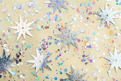 Photo of Shiny glitter on beige background, flat lay