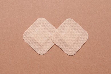 Photo of Contraceptive patches on light brown background, flat lay