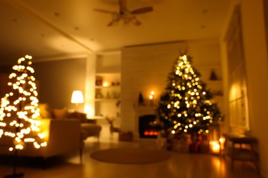 Photo of Blurred view of festively decorated living room with Christmas tree near fireplace