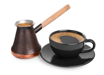 Photo of Metal turkish coffee pot and cup of hot drink on white background