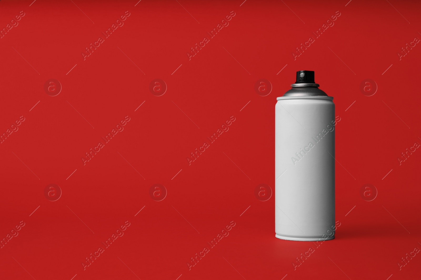 Photo of Can of spray paint on red background, space for text. Graffiti supply